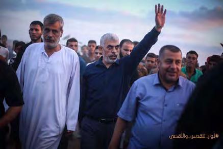 6 Right: Yahya al-sinwar (upraised arm) participating in a "return march" in eastern Khan Yunis.