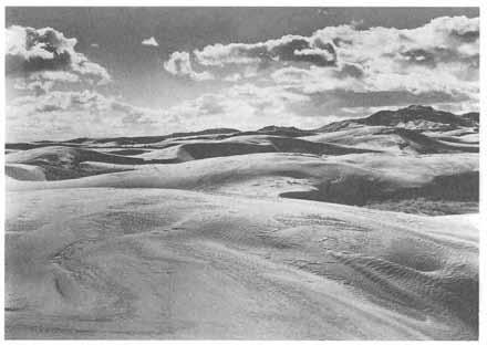 10 HISTORY OF JUAB COUNTY Sand Dunes West of Eureka. (Utah State Historical Society) and west into Juab Valley.