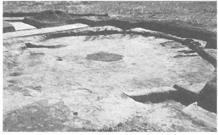 20 HISTORY OF IUAB COUNTY Circular pit house, Nephi Mounds. Note the central fire hearth and that charred roof support beams are still visible.