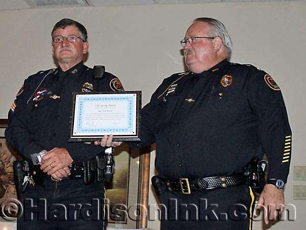 Deputy Chief Clay Connolly holds the certificate as Sgt. Fred Morris (left) looks out at the audience. LIFESAVING AWARD WPD Sgt. Fred Morris accepted the Lifesaving Award.