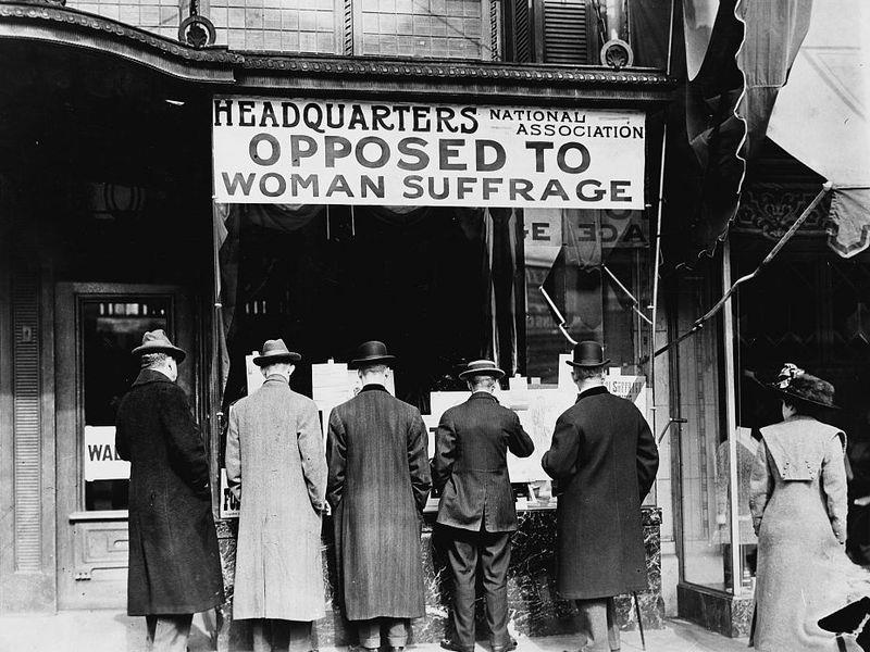 Opposition to Woman Suffrage Men looking at material posted in the window of the