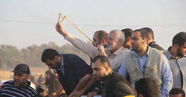 5 Isma il Haniyeh uses a slingshot to fire a stone at IDF forces during the Return March in the central Gaza Strip (Twitter account of Palinfo, May 11, 2018) Yahya Sinwar, head of Hamas Political