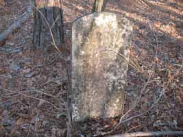 Four have tombstones with the following inscriptions: Elijah L. Bryant, Jefferson D. Bryant, G.W. Ballard, and Joshua Ballard. The rest are unmarked fieldstones.