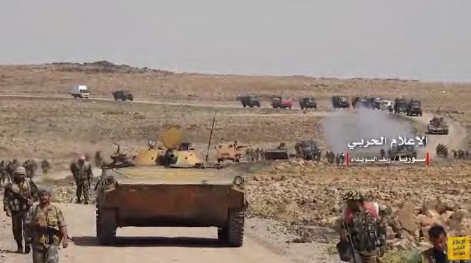 5 Right: Column of armored vehicles of the Syrian army and forces supporting it moving to the ISIS enclave.