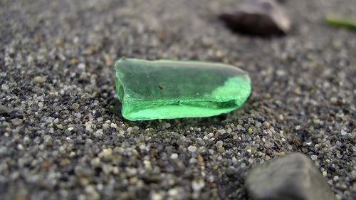 or soda bottles are flung into the ocean. Years pass, or decades, and then one day, there it is upon the shore: a small shard from one of those long ago discarded objects.