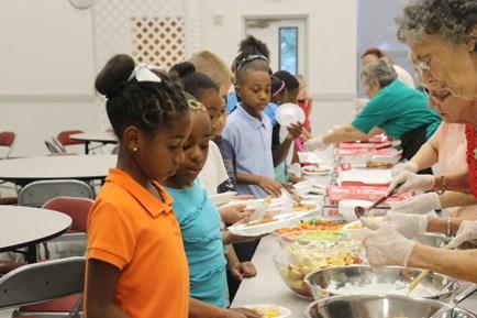 The K of C provide luncheon and gifts for 150 kids from the Boys and Girls Club