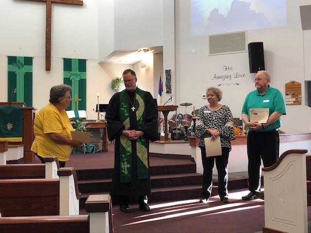 Pastor Mark presenting lay training certificates to