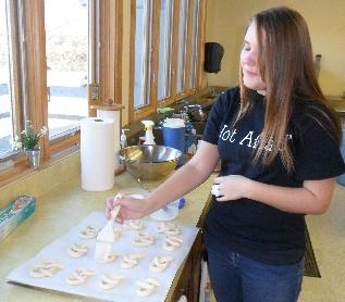 Laverne helped with preparing the oven, and loading and timing the pretzels, while Christina pulled them