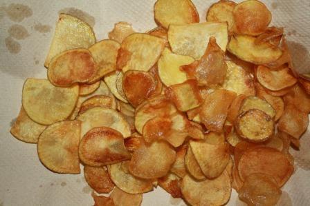 *In honor of National Potato Chip Day: Homemade Potato Chips Peanut oil, for frying 2 potatoes, thinly sliced Salt In a large heavy saucepan, fill oil no more than halfway and heat the oil to 350