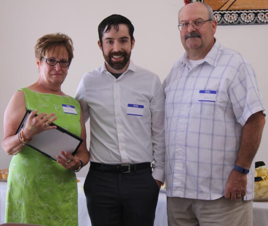 On the left Deb Payne with her son, Bryan receives the Volunteer of the Year award for her recently deceased husband, John Payne who worked with dedication on Counsel 3335 projects and for his