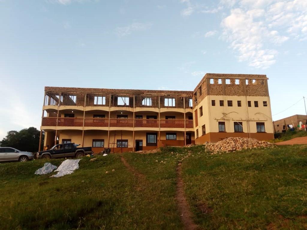 To the Parishioners of St. Ann and John, peace and love from St. Benedict school, Uganda. This is the girls' dormitory yet to be completed. This is where we are now.