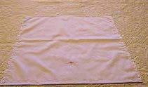 Corporal a white linen cloth placed in the center of the altar on