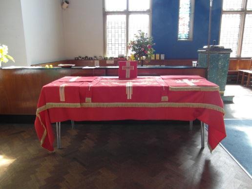 The beautiful cloths adorning the communion table, pulpit and lectern in church