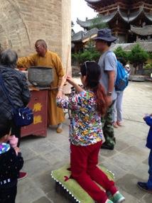 It is quite common to see tourists who are most likely not officially Taoists and Buddhists kneel down and