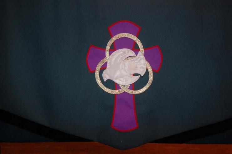 13 Todd: Altar Cloth symbol & Pulpit [[slide]] Table cloth image of dove [[end slide]] On the table, we have a cloth with an image on it. This image adds to the canon of the beliefs that we hold dear.