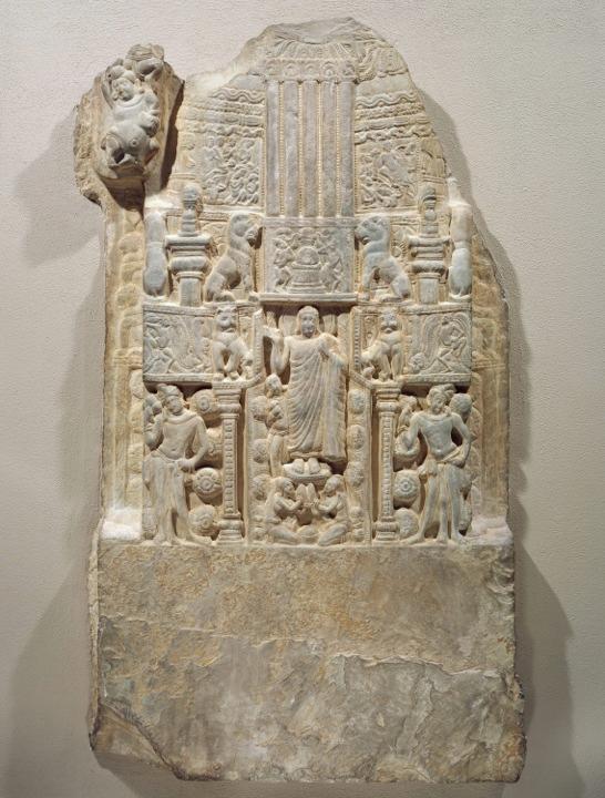 Drum Slab showing the Buddha standing in the Gateway of a Stupa.