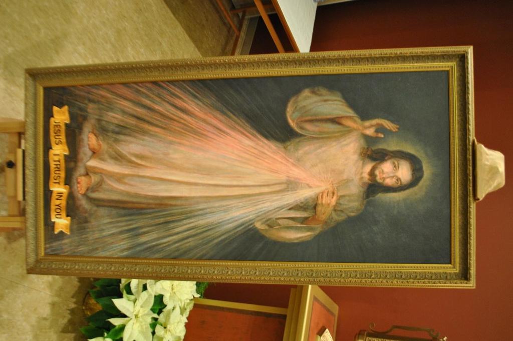 An image of the Divine Mercy is mounted on an easel in the front of the church to the left of the