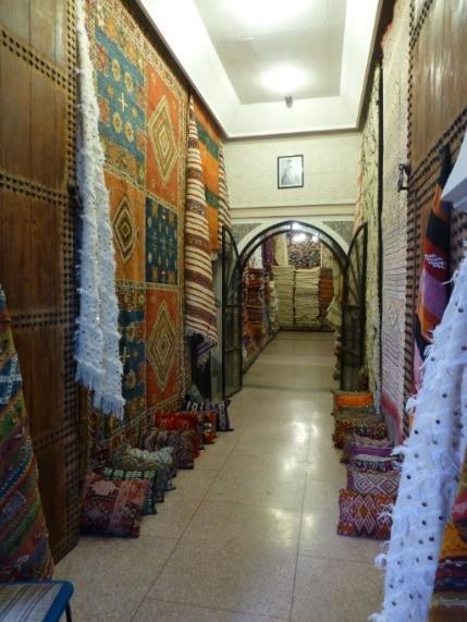 Carpet shop in the medina of Marrakech Day 6: Friday, March 16 Marrakech This morning we check out of our hotel by 8:30 and drive south thru beautiful landscape, with brief stops en route, arriving