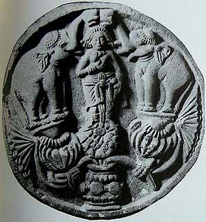 Shunga, 2nd Century BCE, Lakshmi as the lotus goddess bathed by elephants holding uptruned pots in their trunks.