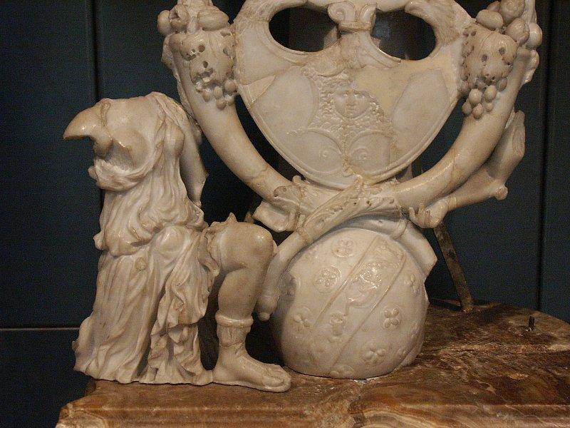 Two Amazons (only one of which is preserved) kneel on the base beside a globe with signs of the Zodiac.