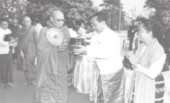 (News on page 1) MNA Secretary-1 Lt-Gen Thein Sein and wife Daw Khin Khin Win donate offertories to a Sayadaw.