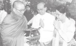 MNA Secretary-1 Lt-Gen Thein Sein and wife Daw Khin Khin Win donate alms to a Sayadaw.