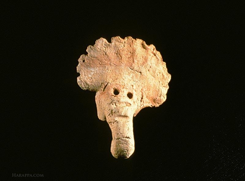Elephant Head figurine with traces of red and white pigment 4,500 year old Elephant head figurine with stylized widespread ears Traces of white and red paint