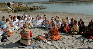 ter Devotees circle around Maharaji giving thanks after a satsang by the banks of the Ganga River. Foreigners Report Continued Pg.