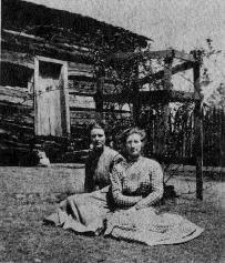 , TN Elmo and Ruth Nichols on lawn of Besty Ann Jared Nichols home with the room of Malinda Byrne Jared in the background. Long after its period of use. Near Buffalo Valley, Putnam Co., TN. Picture from the Book of Jared, by Eleanor Hall, page 230.