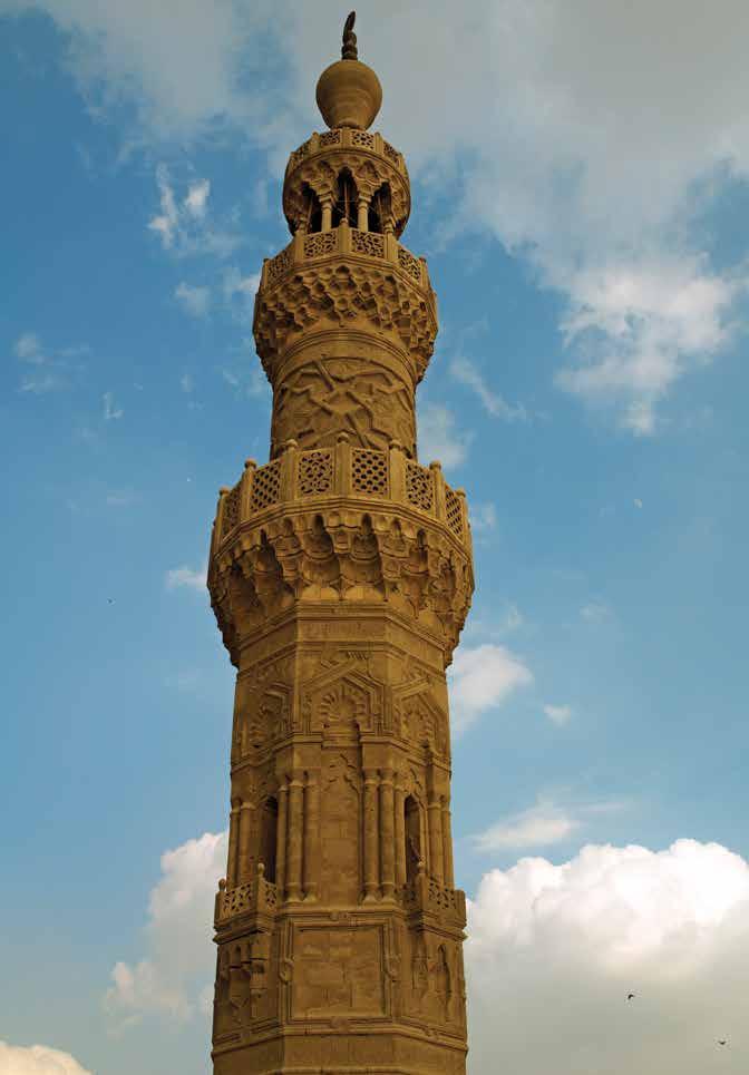 High on a minaret, a muezzin calls the Muslim faithful to prayer five