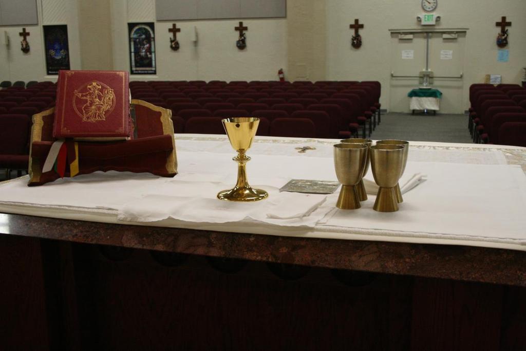 AS3 brings the tray with the Communion Cups and Purificators.