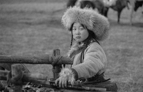 Mongolian child - All bundled up to spend the day outside with her parents and siblings, this Mongolian child will help