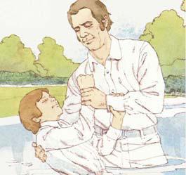 The man who is baptizing puts the person down under