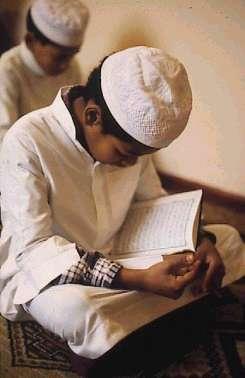 ABOVE: Muslims are encouraged to study the Qur an from a very young age. The Muslims consider the Qur'an to be a miracle by which the authenticity of Muhammad's mission is proven.