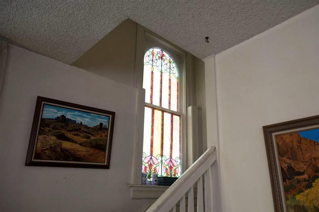 Stair case, stained glass window and wood
