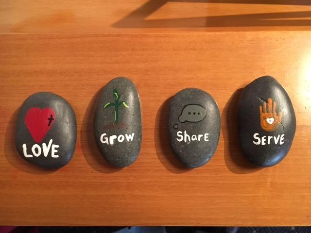 Each of the new icons have been painted on stones along with a label on the bottom.