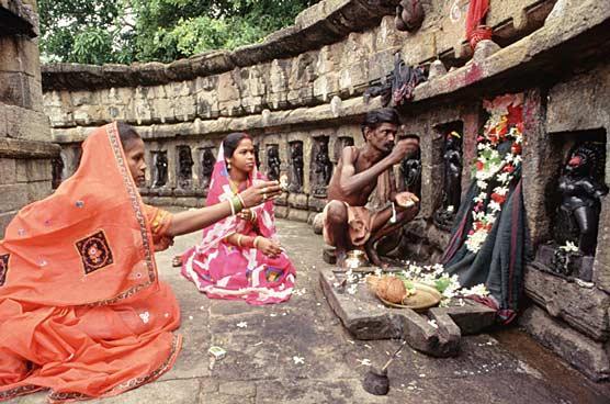 Hindus Praying at a Shrine The circular, open-air temple where these Hindus worship is in Orissa, a state in eastern India.