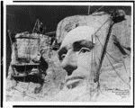 15. Sculpted face of Abraham Lincoln and construction equipment on Mount Rushmore, South Dakota A great