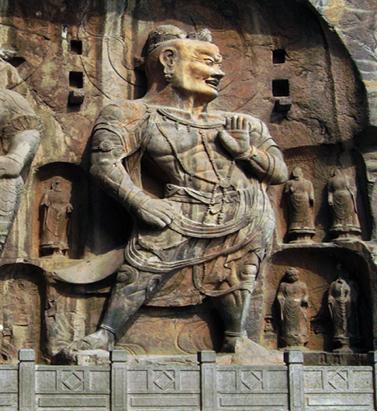 ! His loin cloth is made up of the skin of a tiger, whose head can be seen on his left knee! His outstretched left hand brandishes a vajra (symbolizing knowledge)!