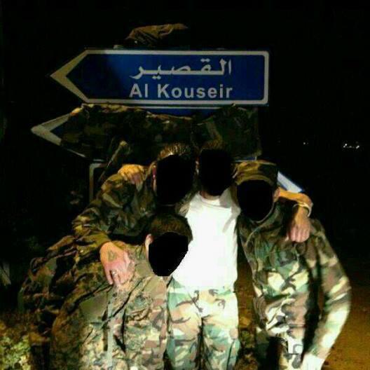 Hizballah Cavalcade: Hizballah s Multiplying Qusayr Martyrs By Phillip Smyth Figure 1: Hizballah fighters pose under a road sign pointing to the Syrian city of Qusayr. (Source: Facebook).