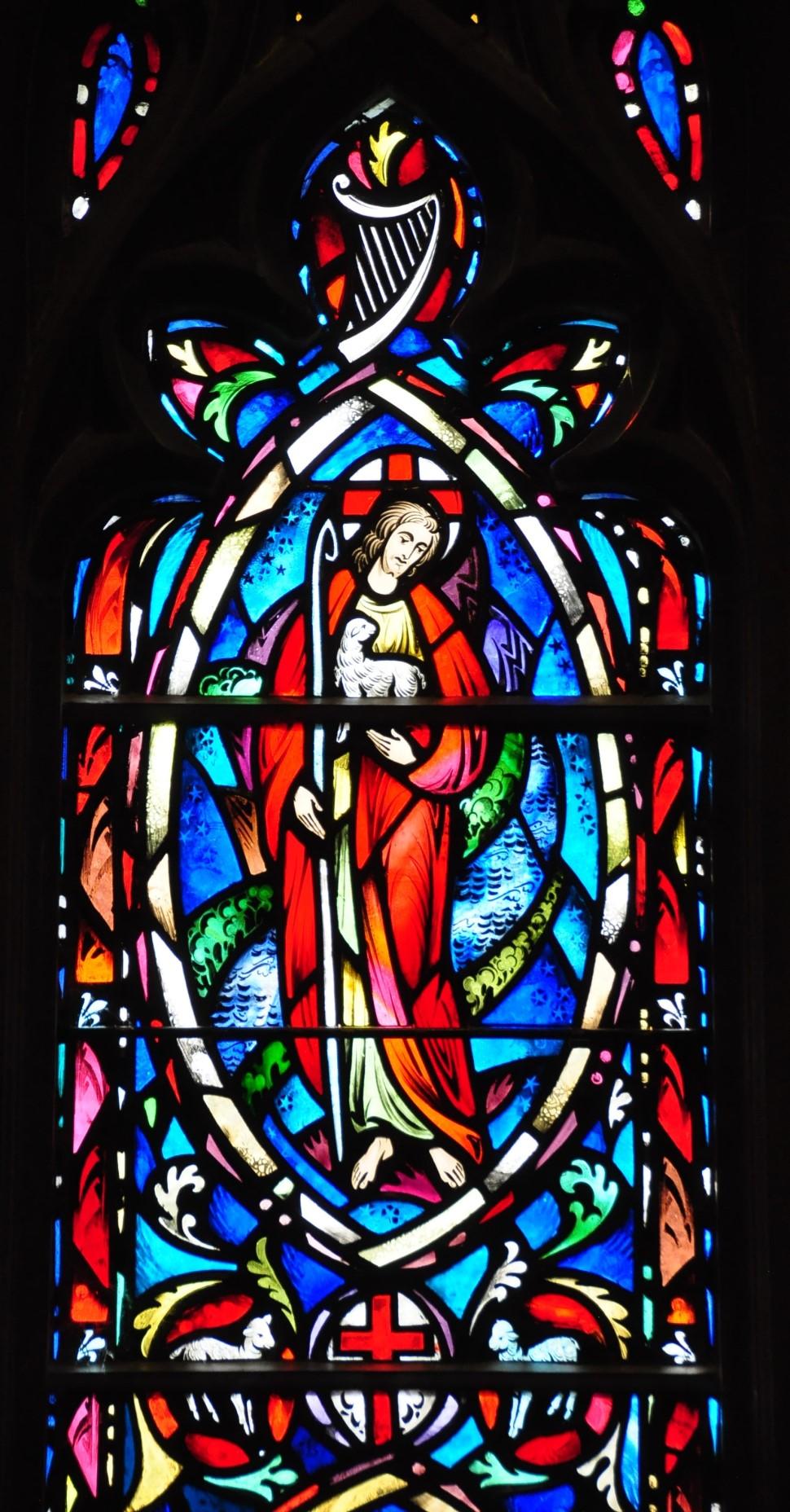 The Poetry Window: The middle aisle window on the left suggests the Poetry of the Bible. The lower medallion symbolizes the return of the prodigal son who kneels before the forgiving father.