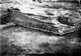 in width and reinforced at frequent intervals with rectangular salients or bastions. The fortifications were of mud bricks.