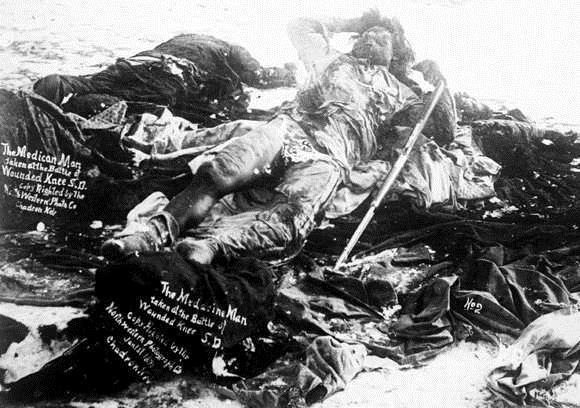 View of the slain frozen body of a Native American Lakota Sioux medicine man on the battlefield at the site of the Wounded Knee