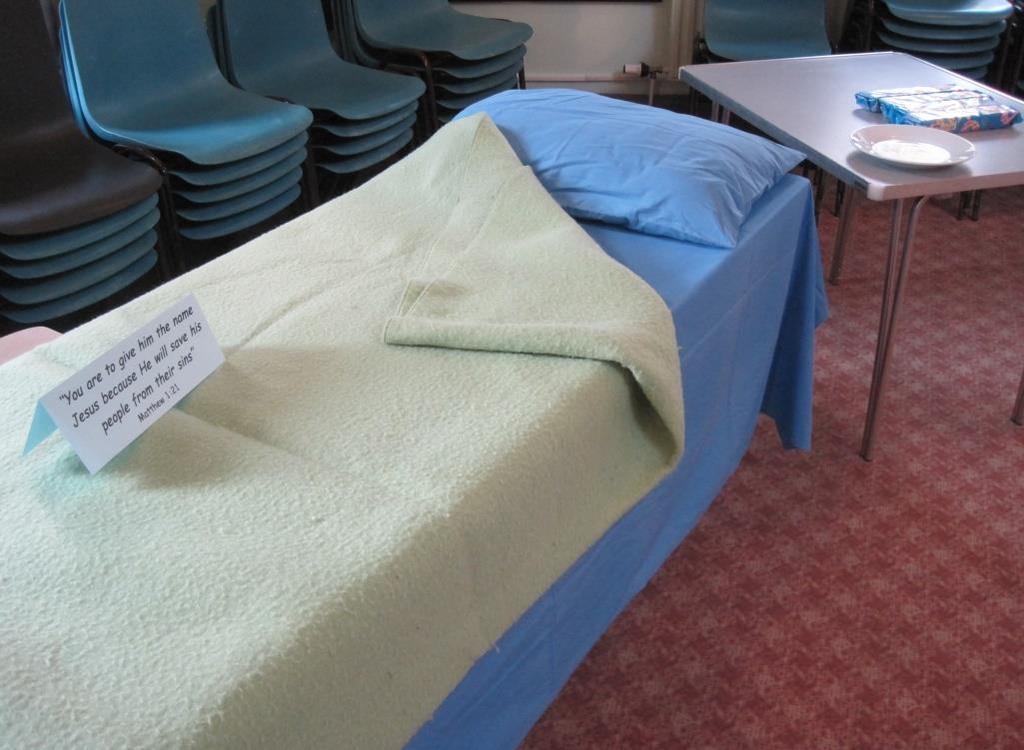 10 Station 8: An angel visits Joseph Items Needed: Two tables covered in a sheet On top of the sheet is placed a pillow and a blanket made to look like a bed To one side of the bed is another table.
