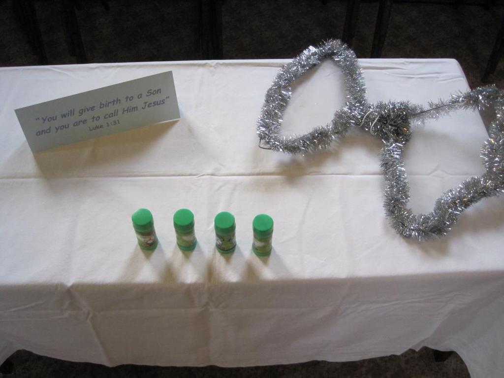 9 Station 7: The angel Gabriel visits Mary Items Needed: A table covered in a white sheet Some pots of bubbles and a pair of angel wings made out of wire and silver tinsel Card with Luke 1:31 (See