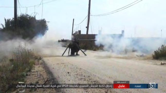 10 Right: ISIS operative launches a rocket at a Syrian army position in a village north of Albukamal.