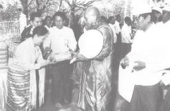 MNA General Thura Shwe Mann and wife Daw Khin Lay Thet offer provisions to a Sayadaw.