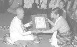 NLM Daw Khin Lay Thet presents certificate of title to a nun.