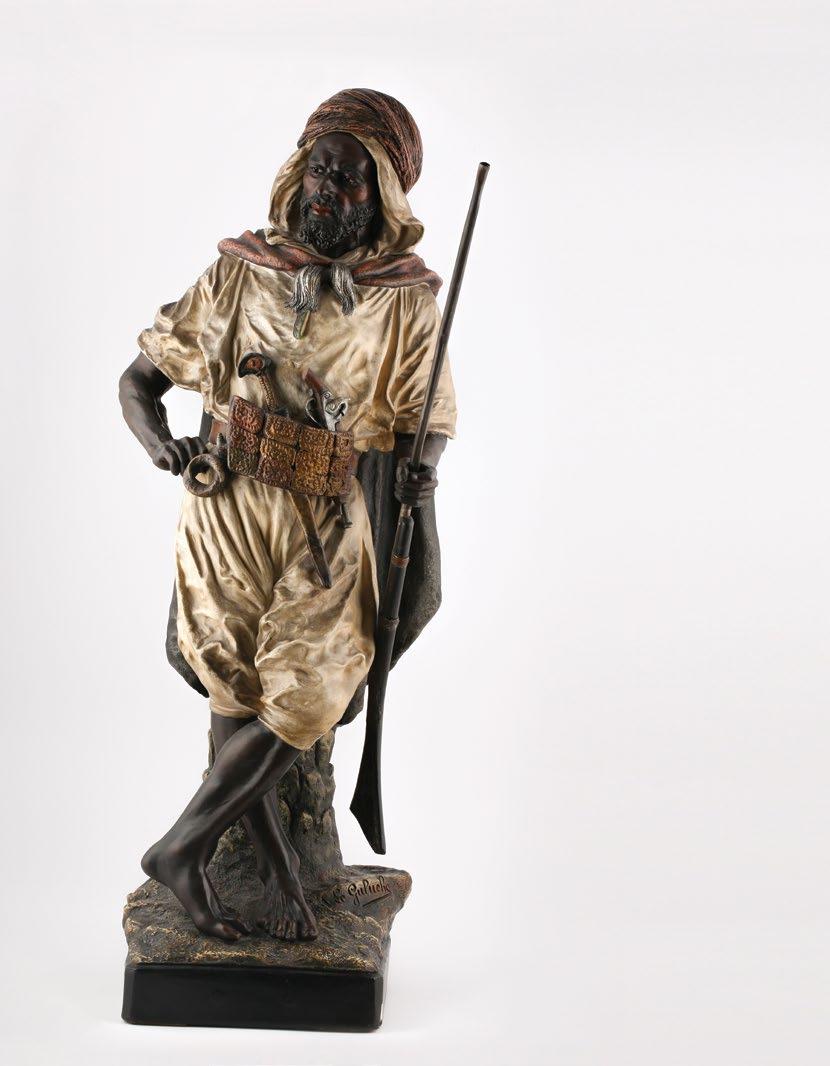 65. Joseph Le Guluche (French, 1849-1915) Kabyle Warrior جوزيف لو جولوش )فرنسي 1849-1915( محارب القبائل Polychrome-patinated terracotta figure of a warrior with moveable riffle. signed on the base «J.