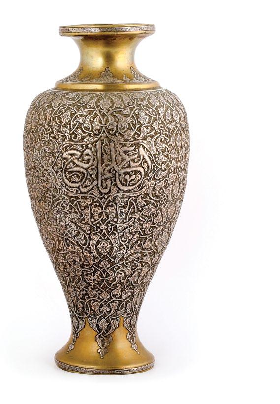 135. A Syrian Islamic Brass Vase مزهرية نحاسية بنقوش إسالمية مرصعة بالفضة with silver inlay, decorated with endless knot, ornate interlacing arabesque design overall and cartouches with calligraphy.
